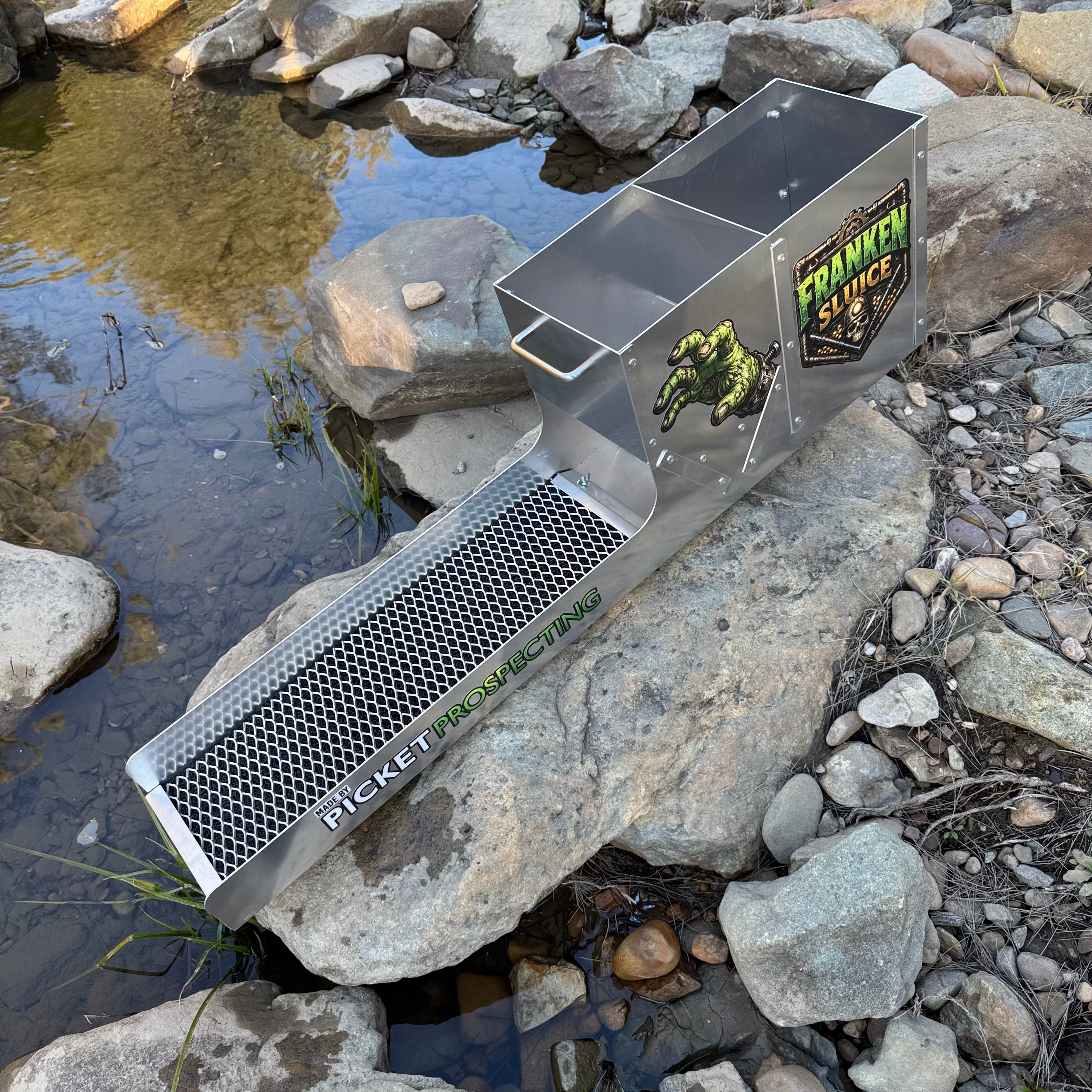 Displaying the side view of an aluminium Franken Sluice, aluminium mesh in a creek setting. With Frankel sluice graphics and a picket prospecting logo.