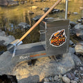 Aluminium rocker box placed on a large rock in a creek setting. Displaying expanded mesh and a classifying sieve.