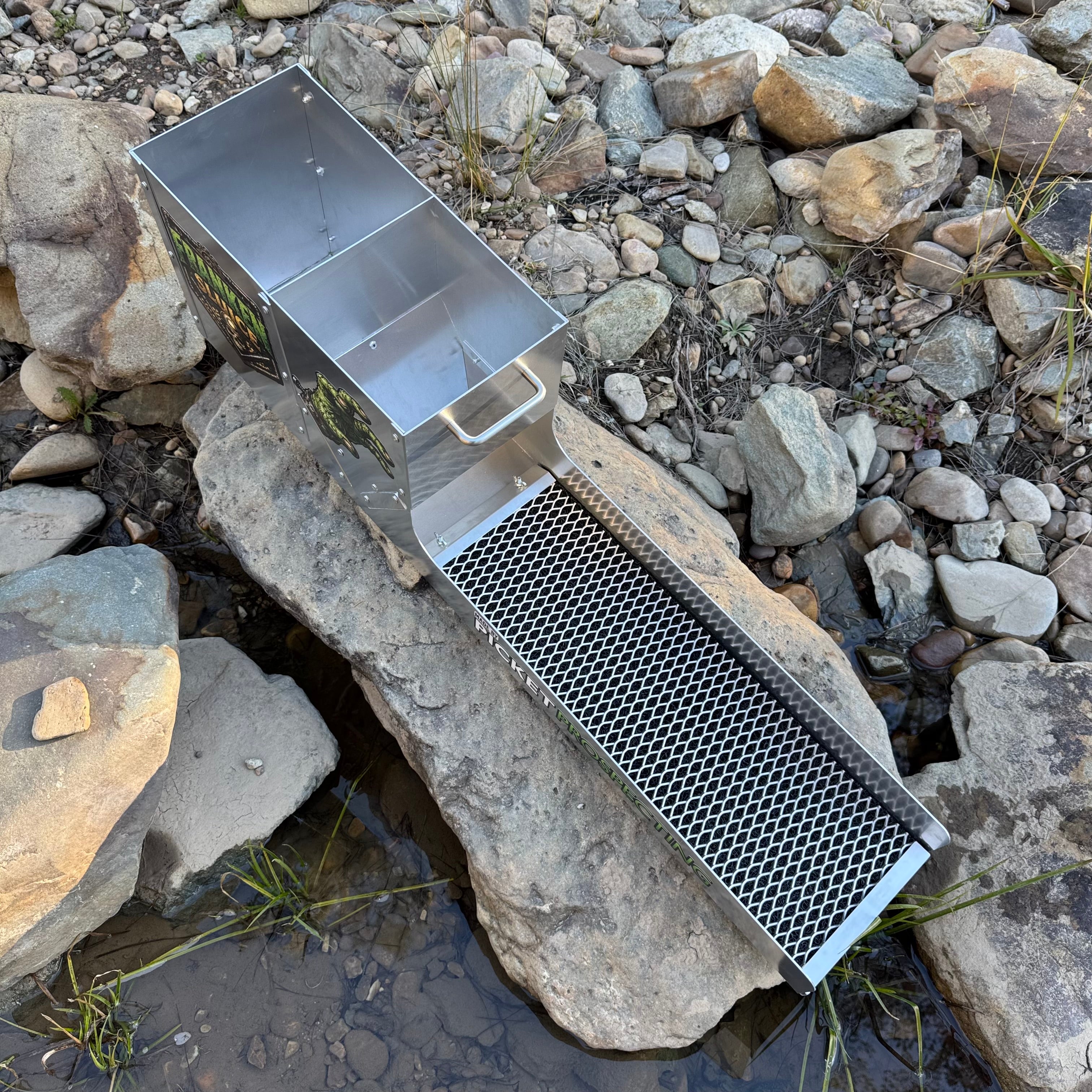 Displaying the top side of an aluminium Franken Sluice, aluminium mesh in a creek setting.